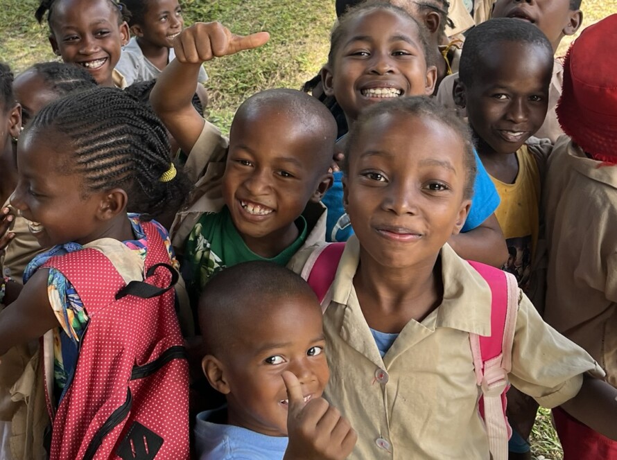 Group of children in primaryschool in the school yard giving thumbs up and laughing Madagascar