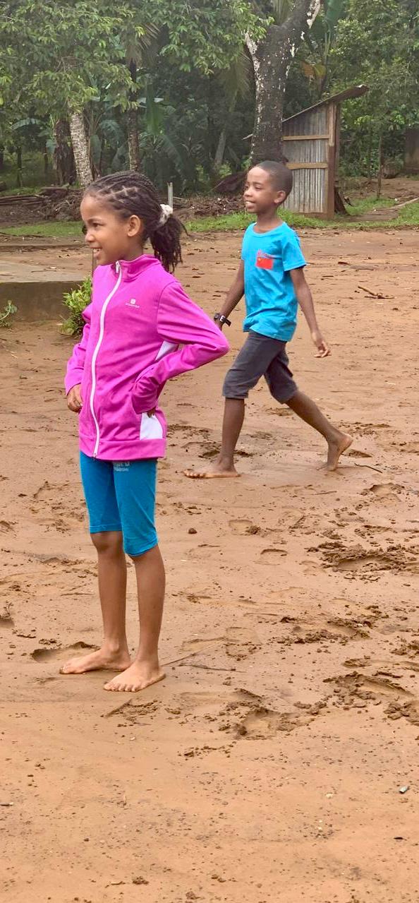 Children in school yard red soil east coast Ile Sainte Marie Madagascar
