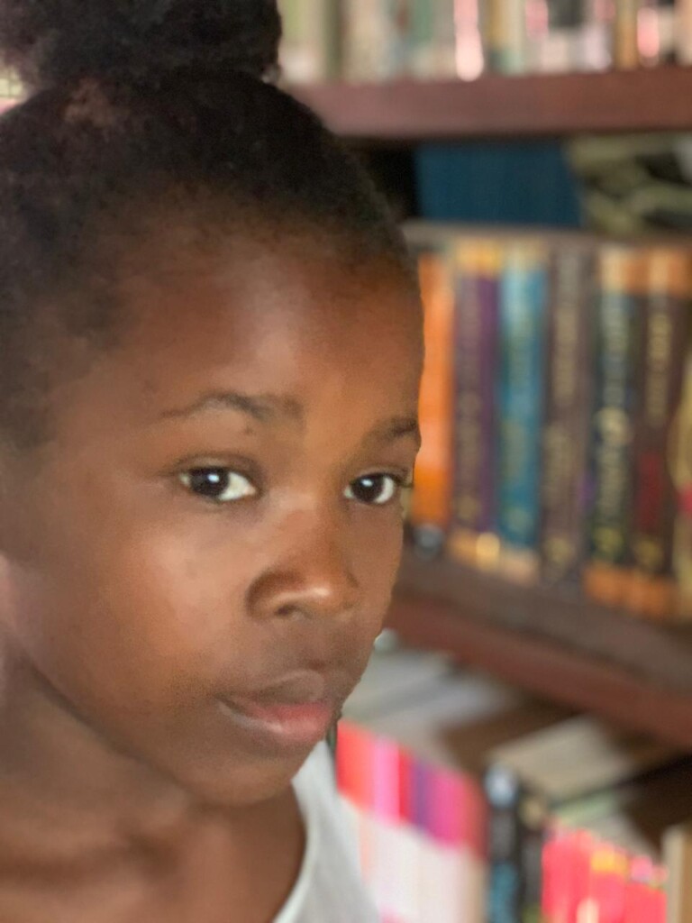 Girl in school library east coast Ile Sainte Marie Madagascar