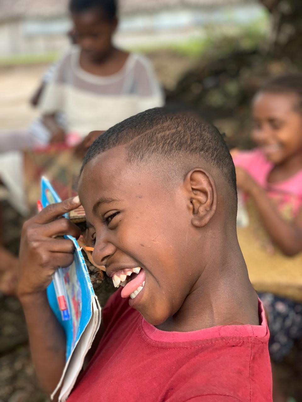 Laughing boy in school east coast Ile Sainte Marie Madagascar