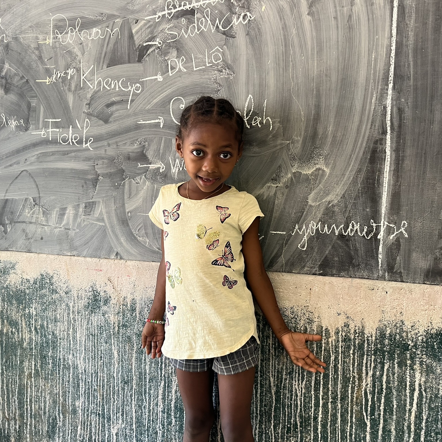 Girl in front of blackboard, Ile Sainte Marie, Madagascar