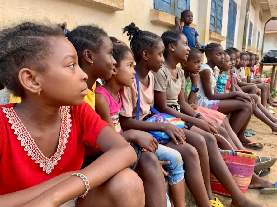 Group of school children sitting outsie school in a small village of Ile Sainte Marie Madagascar