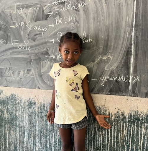 Girl in front of blackboard Madagascar school
