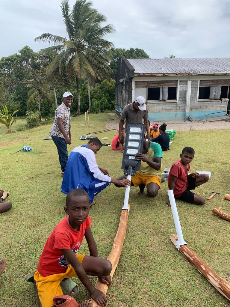 Installing solar lights in the village of Ambohidena