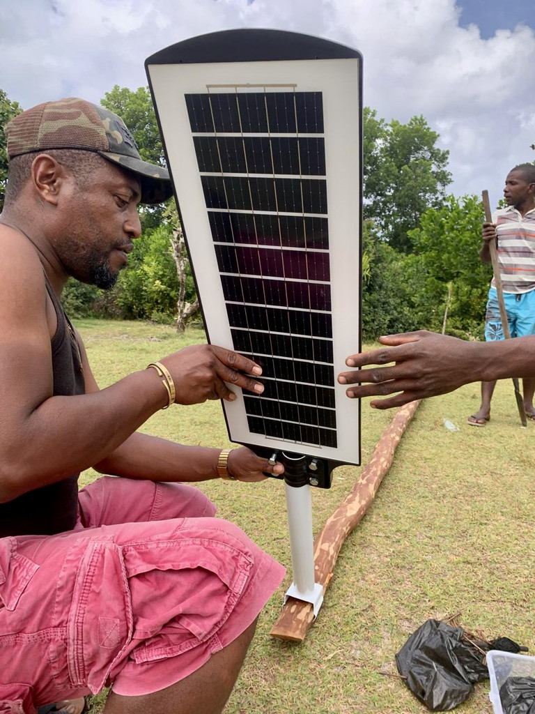 Installing solar lights in the village of Ambohidena