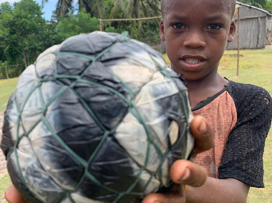 Boy holding a homemade football in Madagascar, Ile Sainte Marie